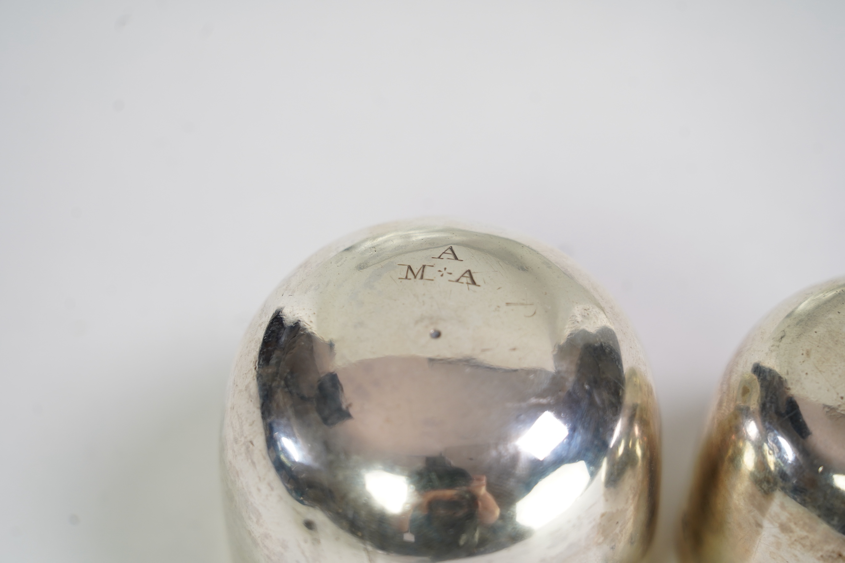 A George II silver tumbler cup by John Payne, London, 1753?, engraved with the initial MA, 45mm, together with a later George III silver tumbler cup by John Payne, London, 1766, engraved with the initials, A.M.A